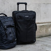 Status Roller Bag +42L - Black - Black - Wheeled Roller Luggage | Dakine